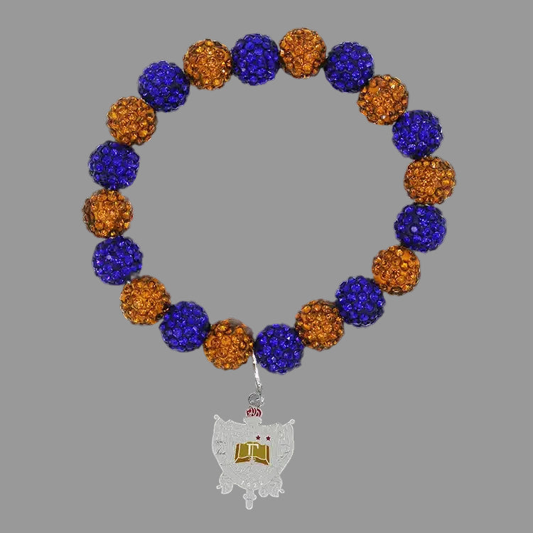 Bracelet with blue and yellow beads and a silver charm on a black background