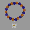 Bracelet with blue and yellow beads and a silver charm on a black background