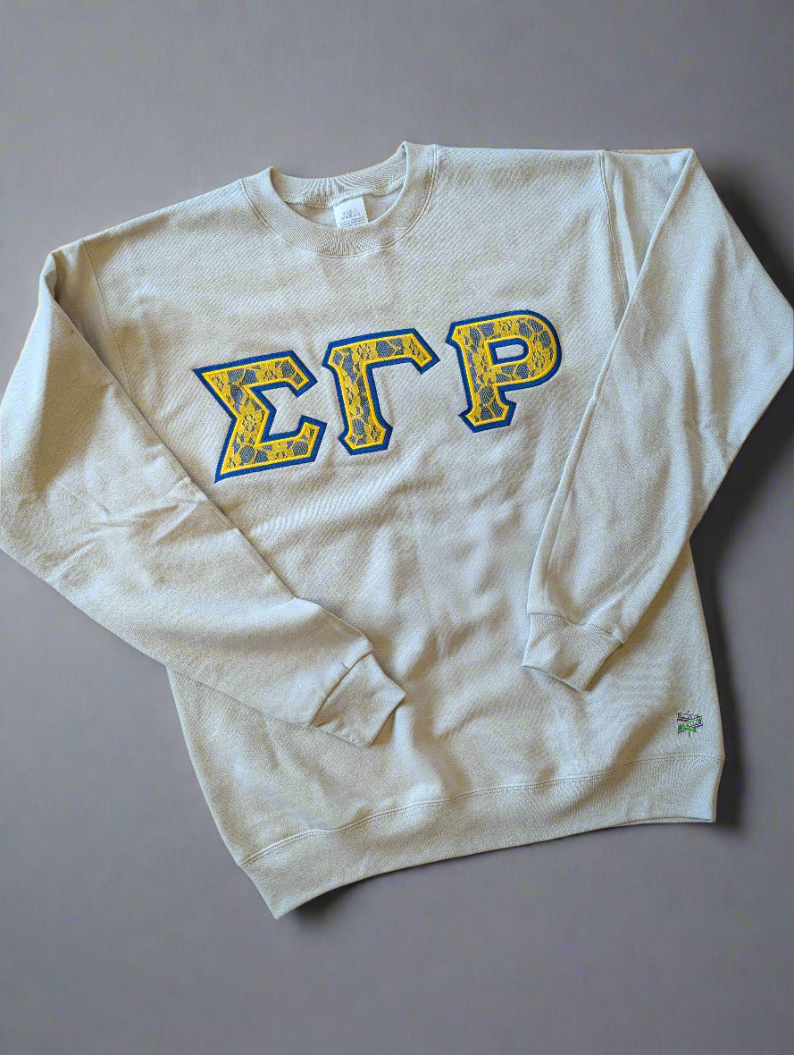 White sweatshirt with blue and yellow letters on a gray background