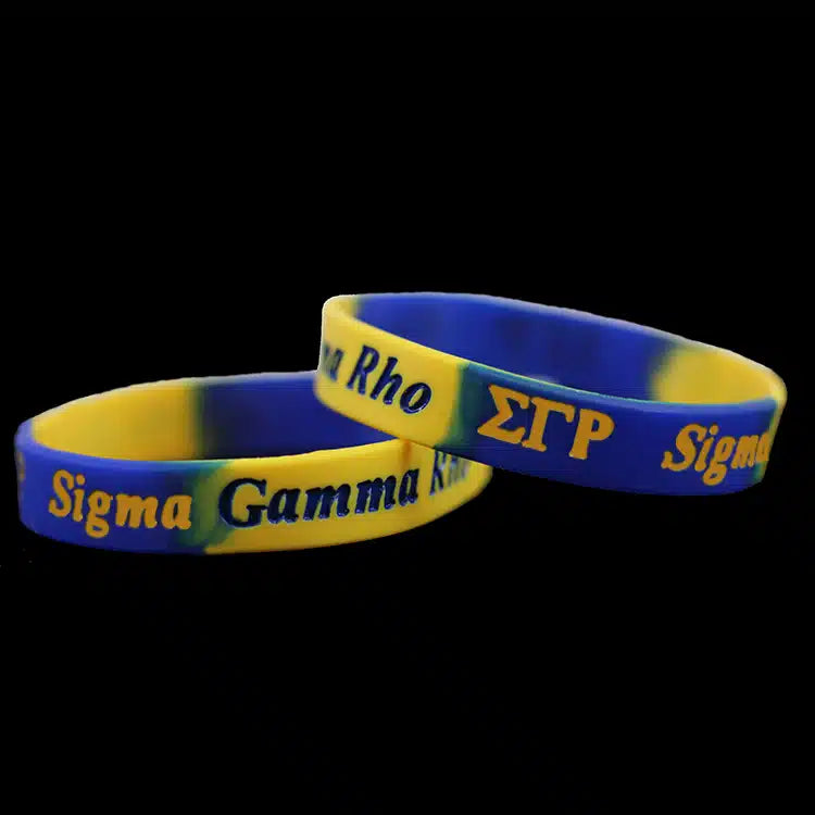 Two blue and yellow wristbands with Greek letters on a black background