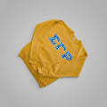 Yellow sweatshirt with blue lettering on a wooden surface