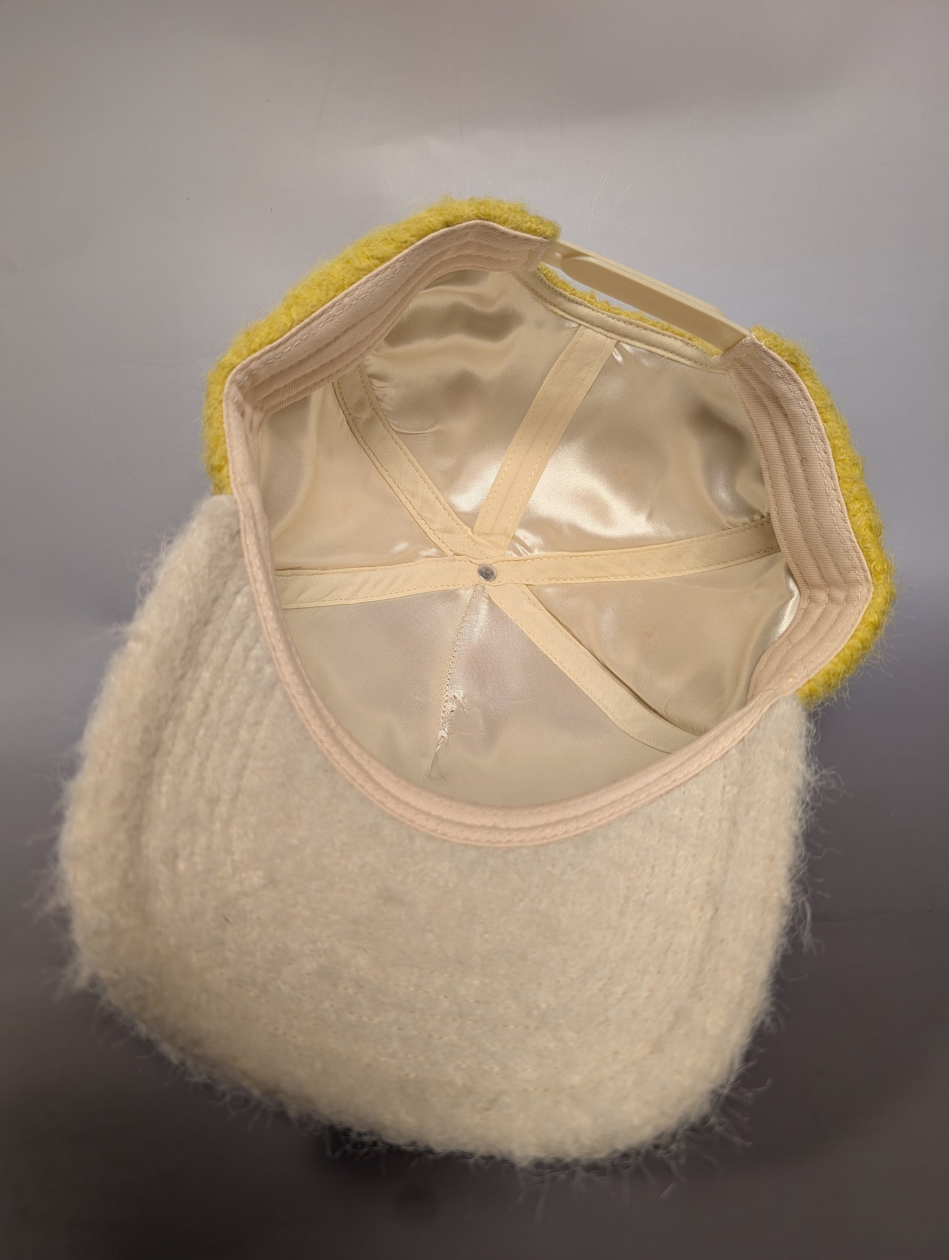 cream colored hat with satin-lining