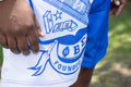 Close-up of a blue and white sports jersey with a logo and text.