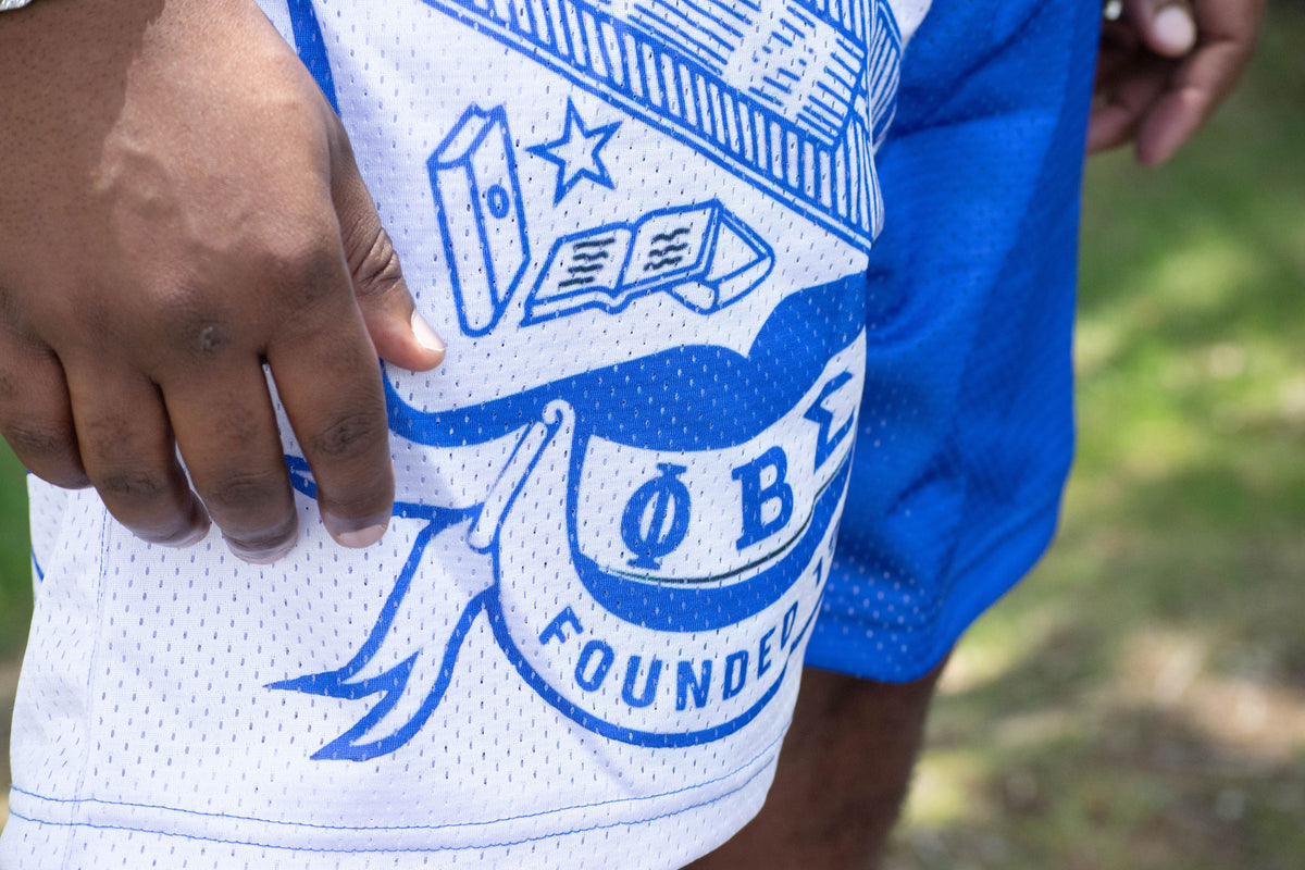 Close-up of a blue and white sports jersey with a logo and text.