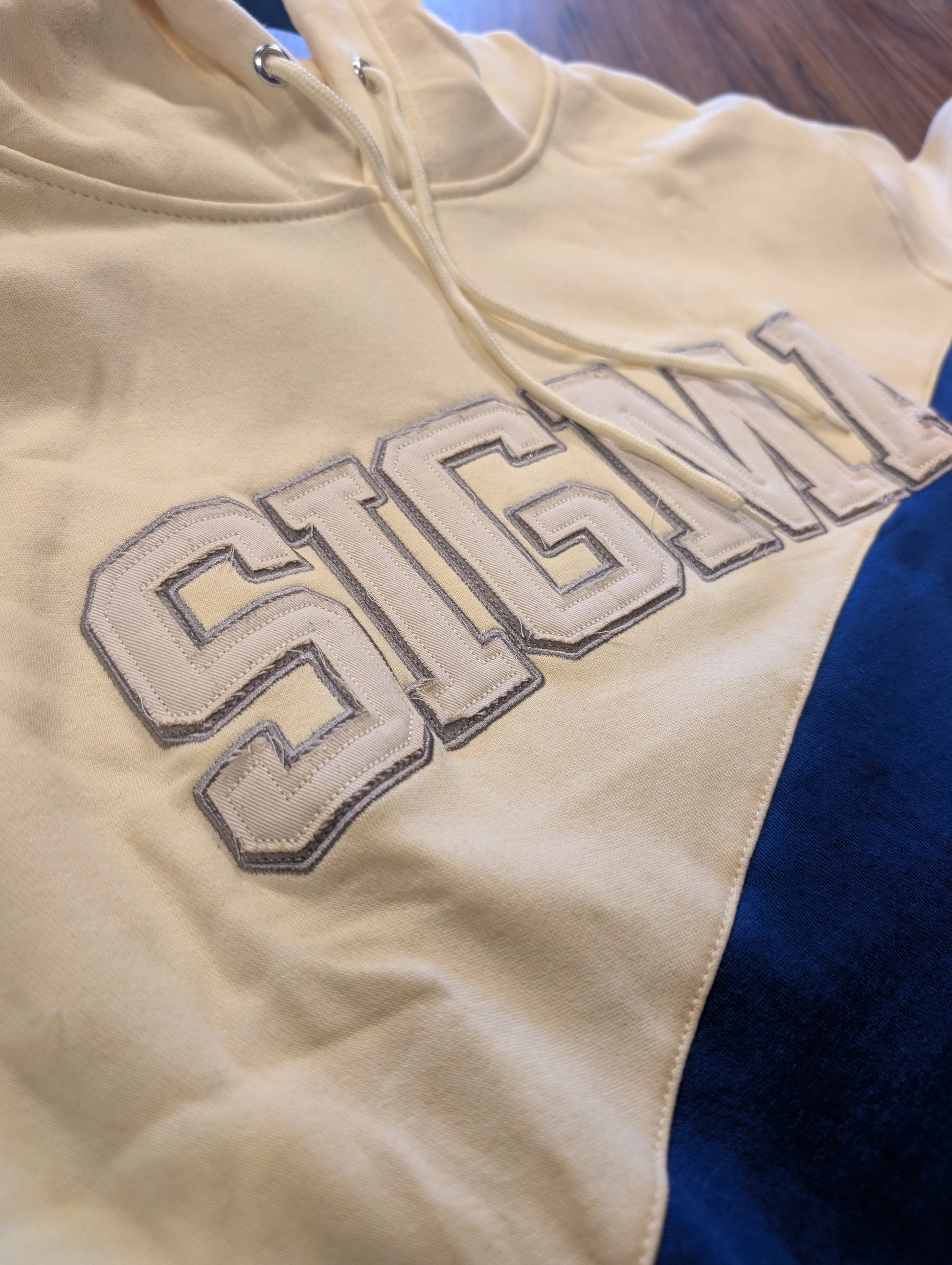 royal blue and cream hoodie with 'SIGMA' on chest