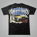 Black t-shirt with a race car graphic on a wooden surface
