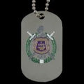 Dog tag with emblem and two swords on a reflective surface