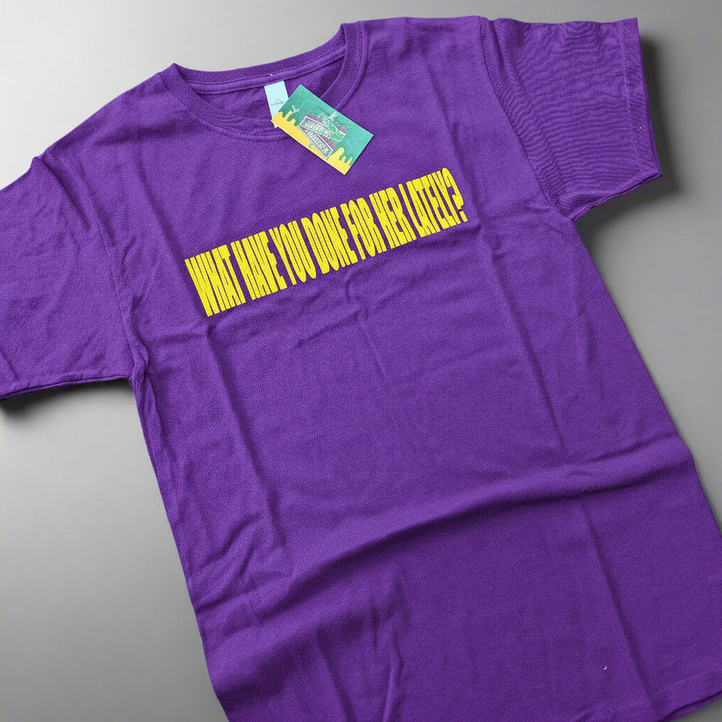 purple t-shirt with yellow text on a wooden surface