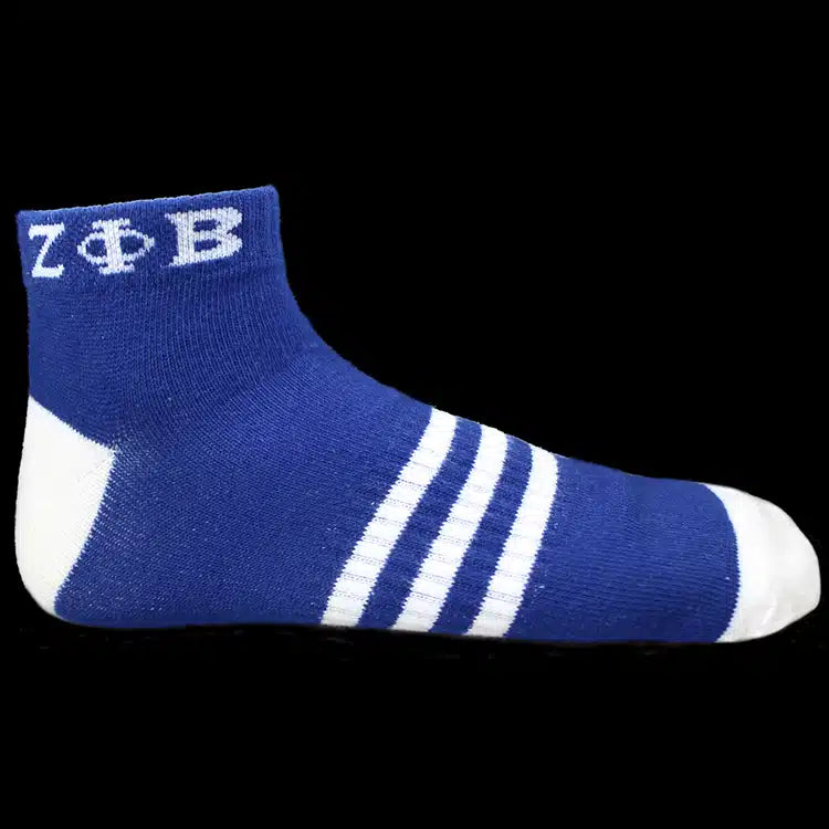 Blue sock with white stripes and 'Zeta Phi Beta' letters on a black background