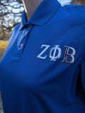 Blue polo shirt with 'ZΦB' letters on left chest