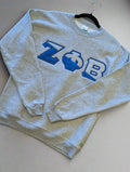 Gray sweatshirt with blue letters 'ZΦB' on a plain background