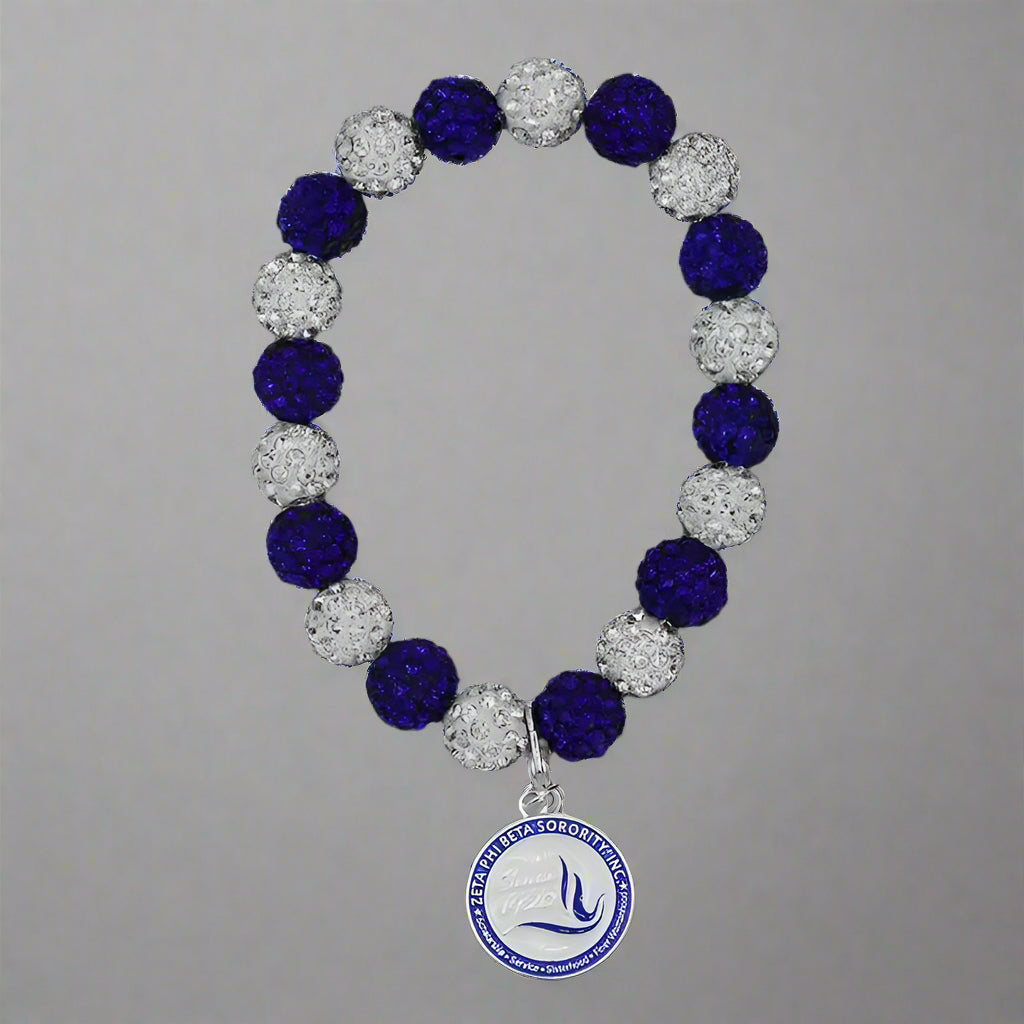 Bracelet with blue and silver beads and a logo charm on a black background