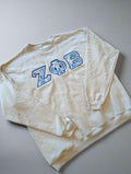Beige sweatshirt with blue lettering 