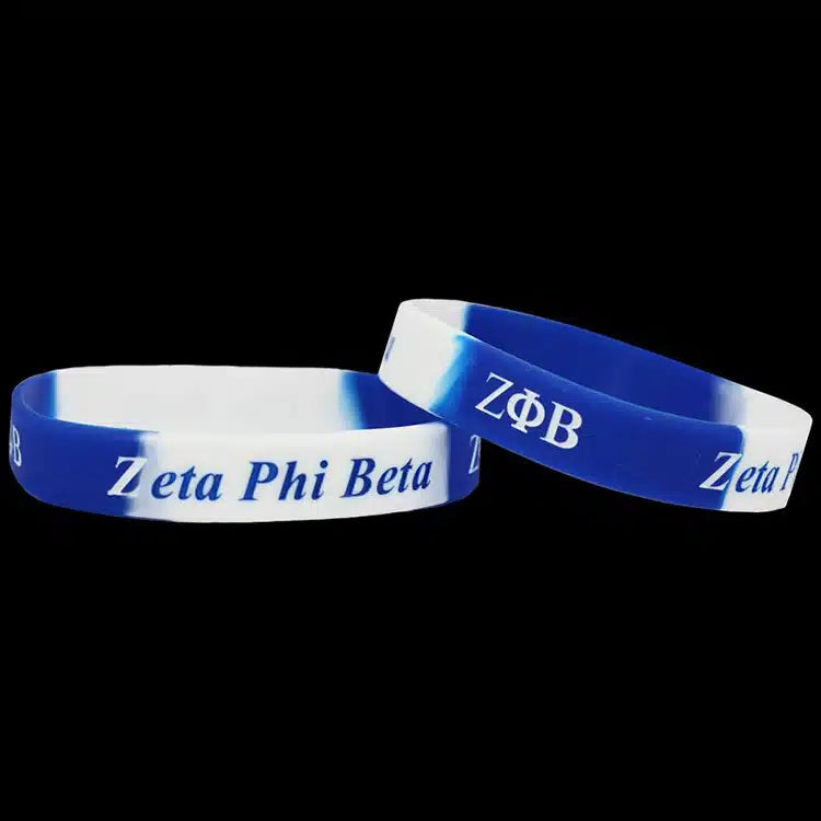 Two blue and white wristbands with 'Zeta Phi Beta' text on a black background