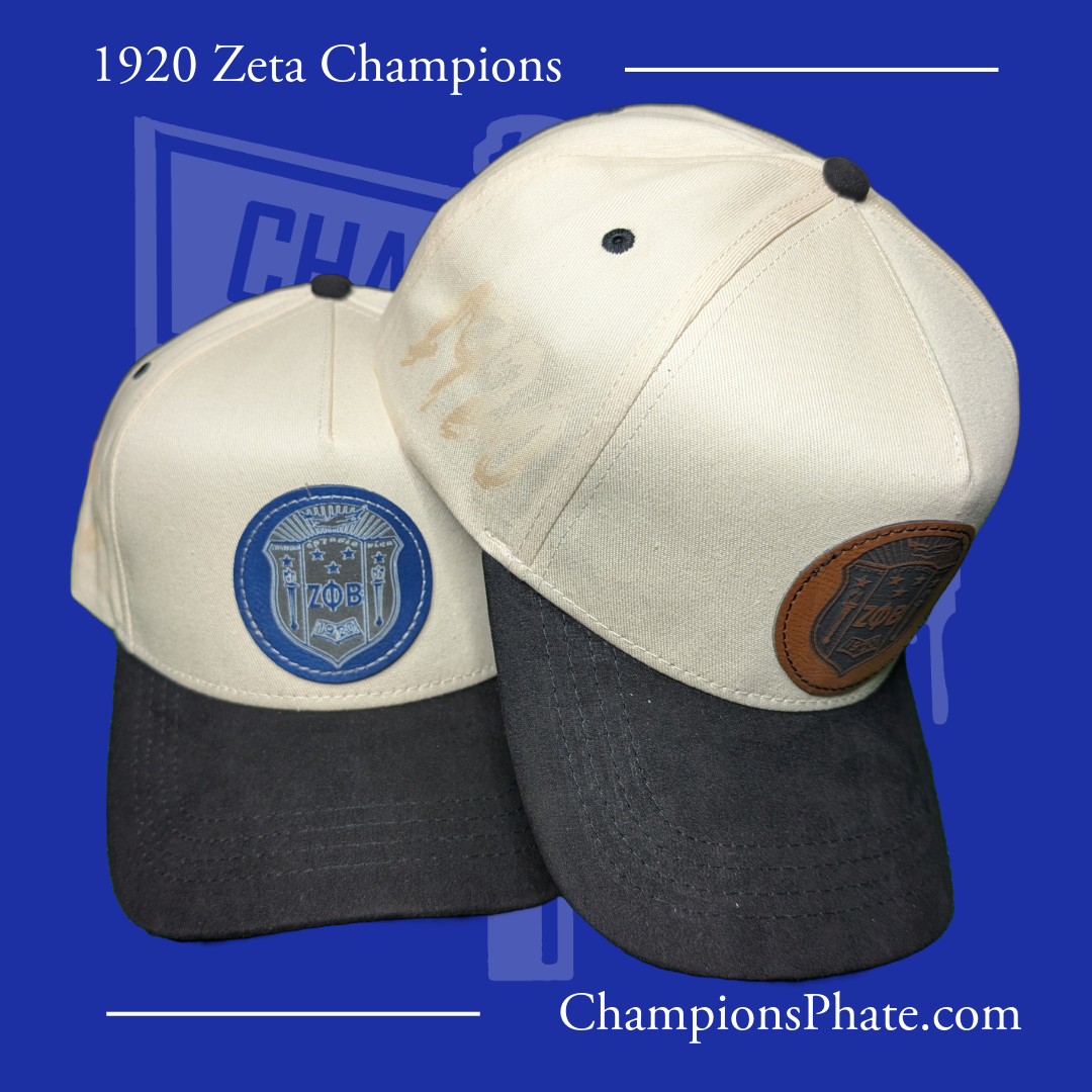 Two baseball caps with logos on a blue background, featuring text about 1920 Zeta Champions and a website address.